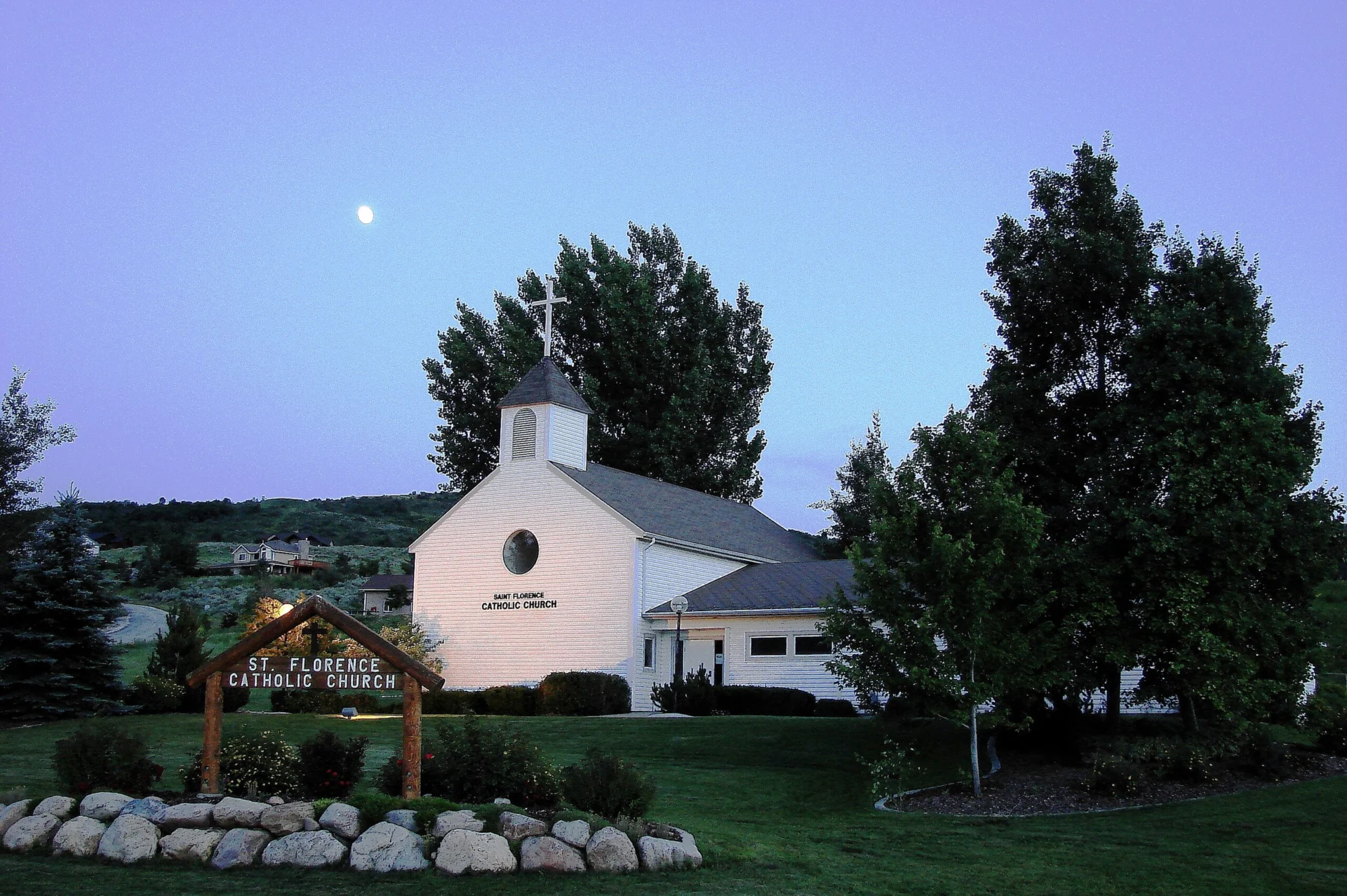 St. Florence Catholic Church at dusk with a full moon.