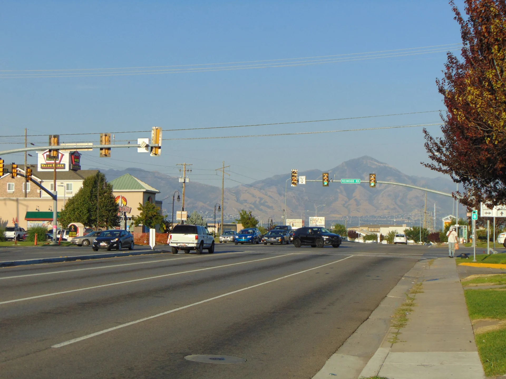 Redwood Road intersection with traffic lights and mountains in the background.
