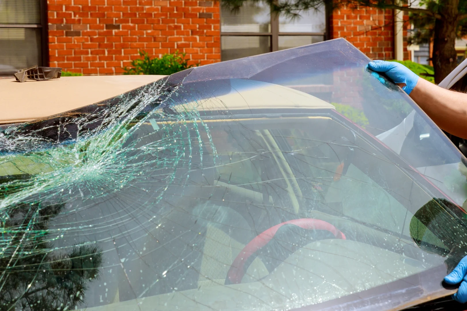 Technician replacing a cracked car windshield