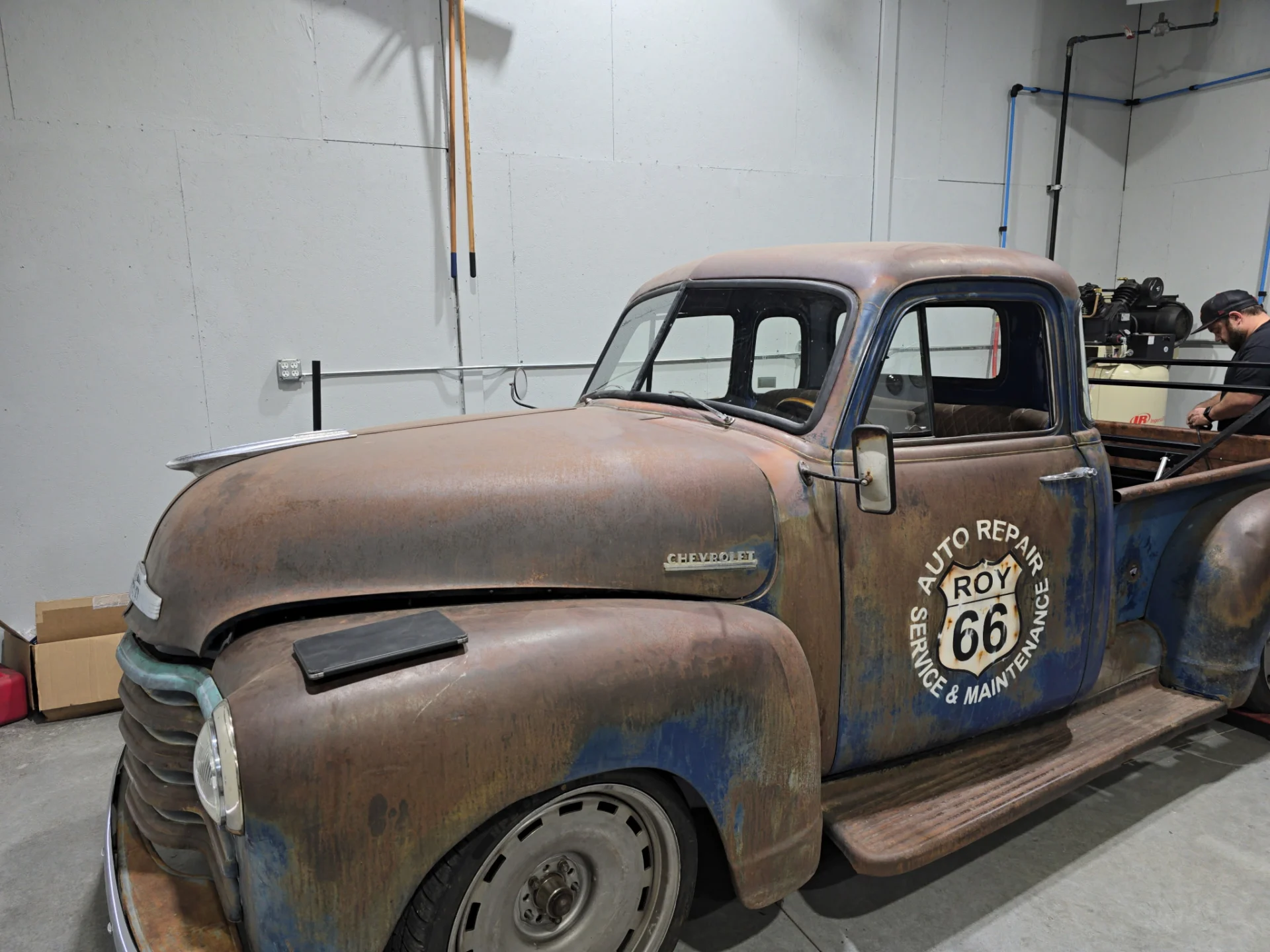 Rusty Chevrolet pickup truck with Route 66 auto repair logo
